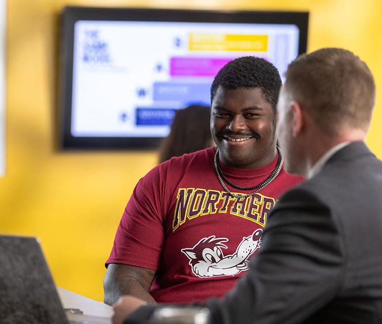 Student talking with faculty member